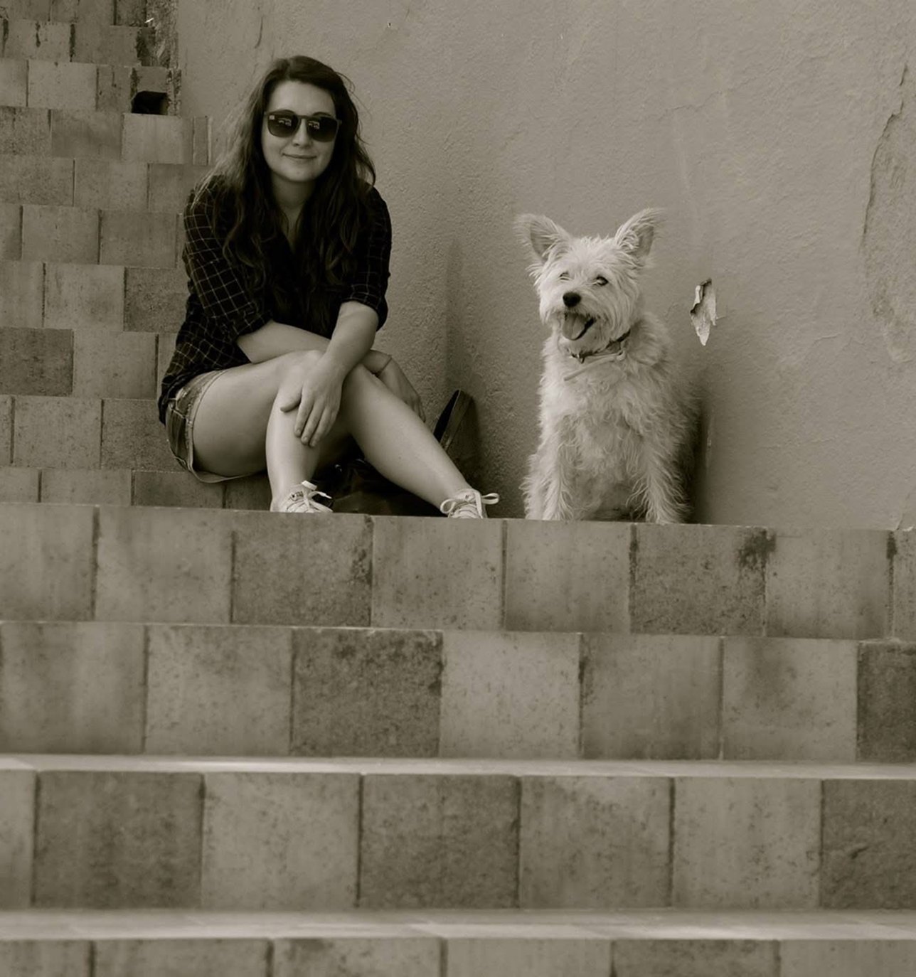 Heather sitting on concrete steps with her dog
